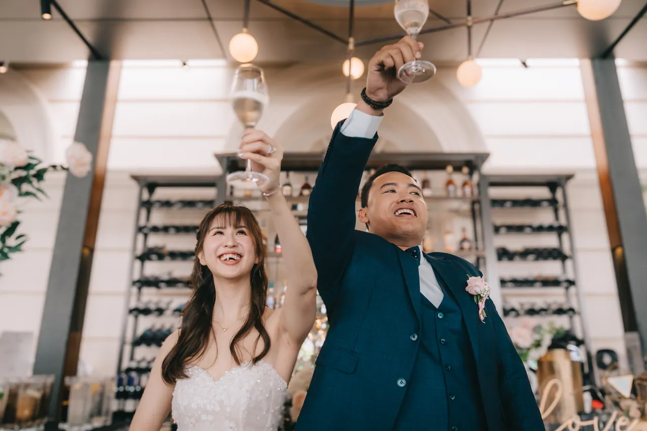 Bride and groom raise their glasses for the toast.