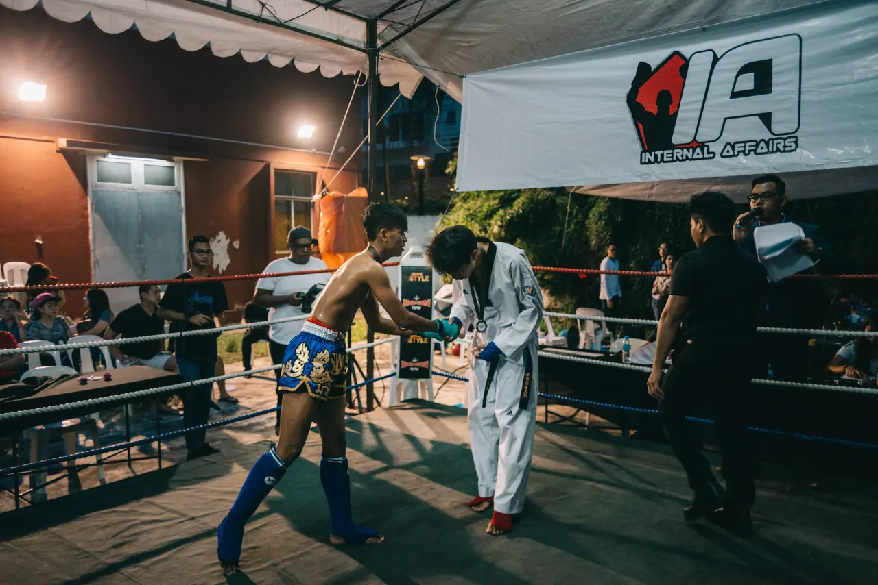 Two fighters circle each other in the ring.