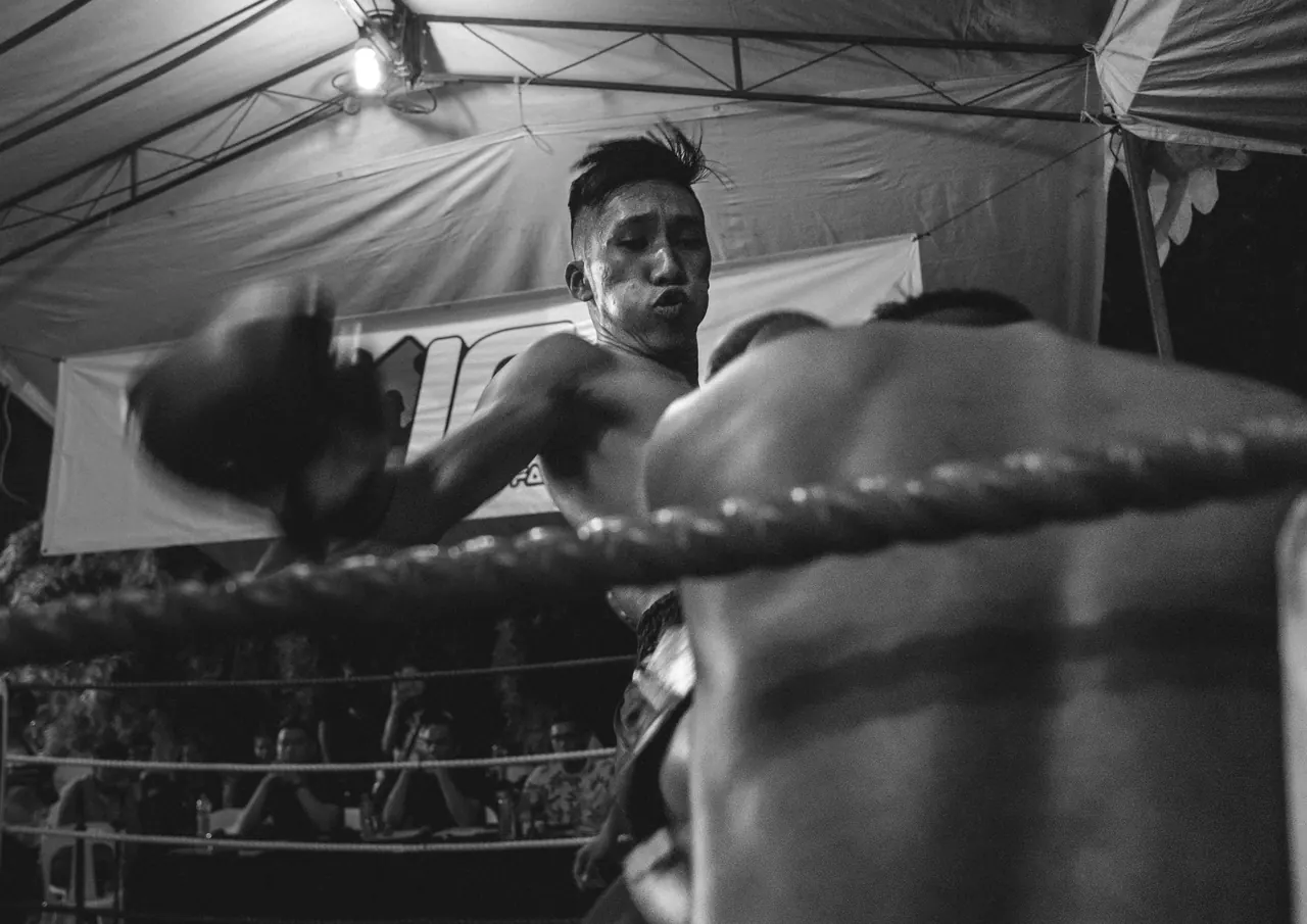 Black and white: a fighter on the ropes.