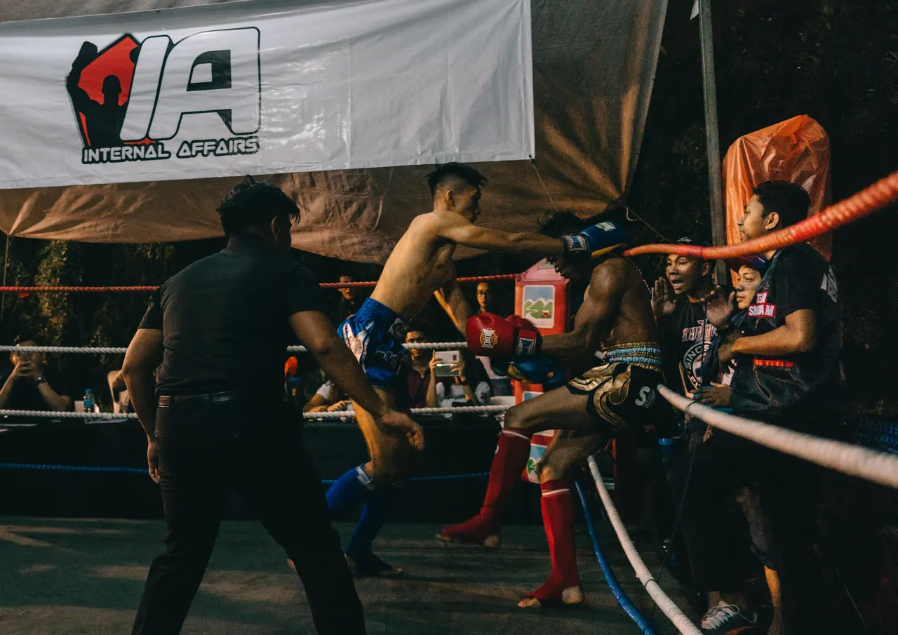 A referee steps between two fighters.