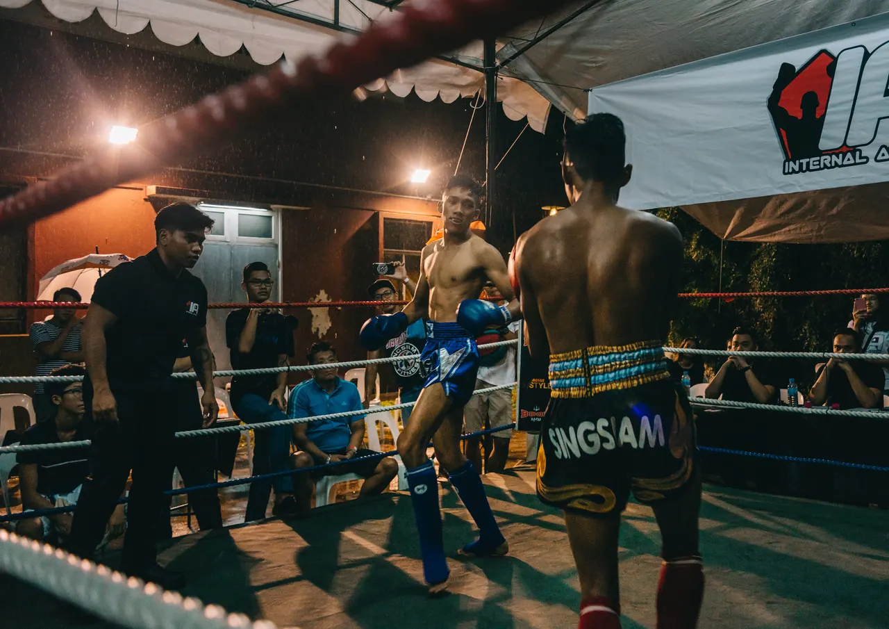 Two fighters trade blows under the lights.