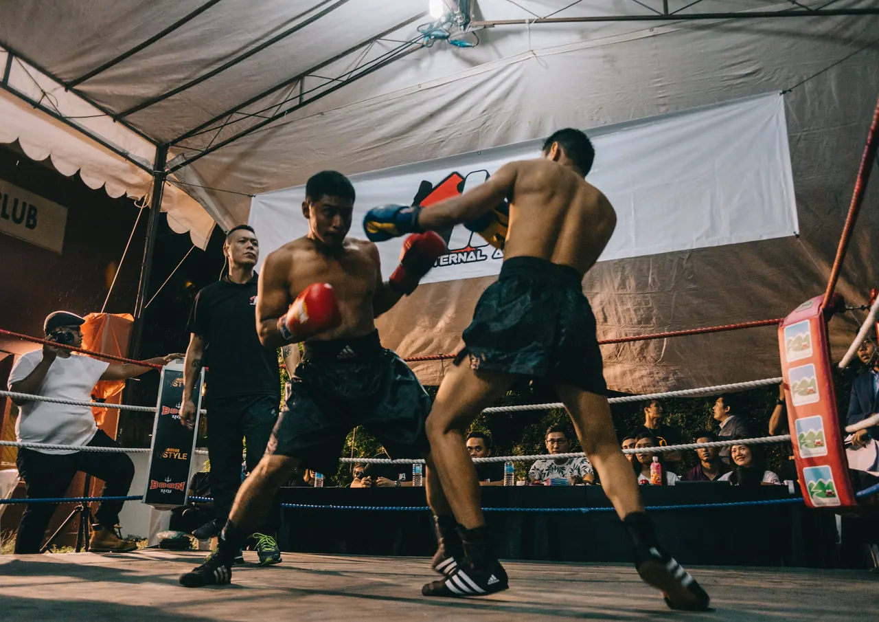 A fighter throws a punch across the ring.