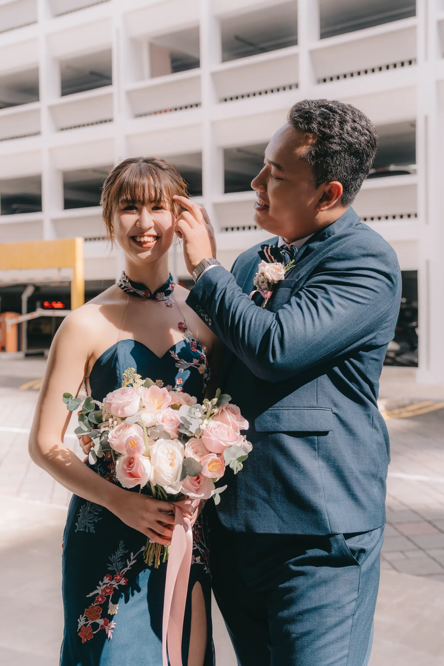 The groom tucks the bride’s hair behind her ear.