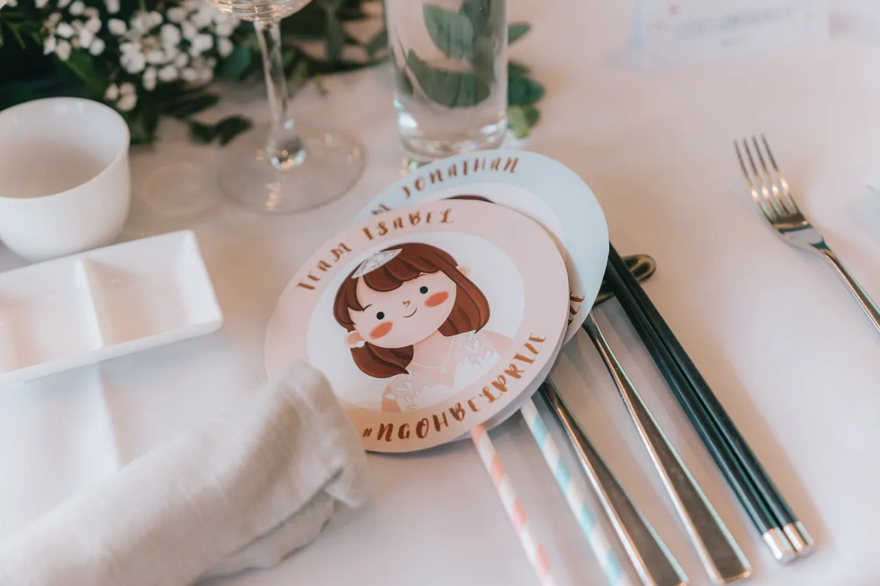 A place card with a cartoon of the bride on a set table.