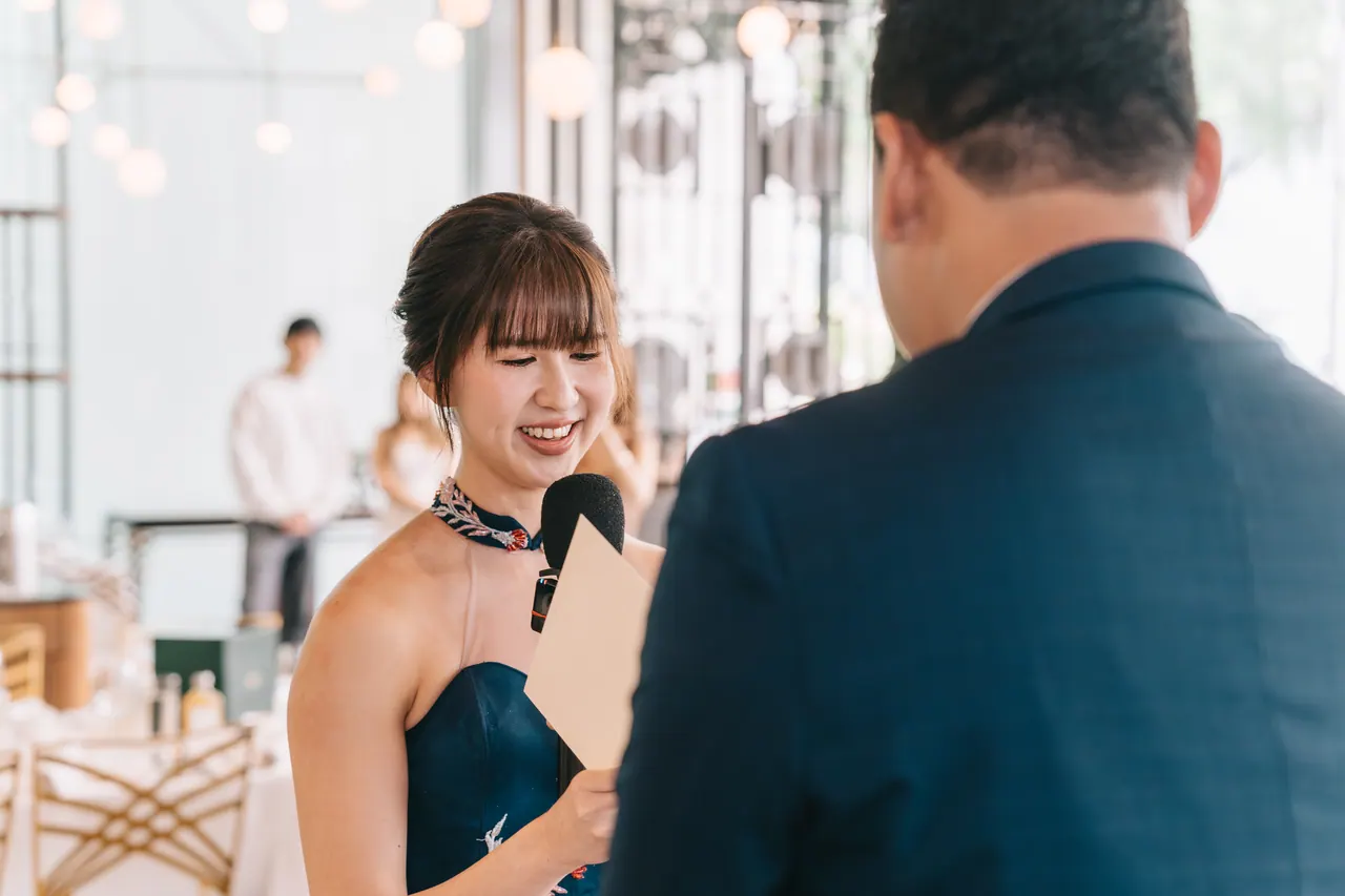 The bride, laughing, faces the groom.