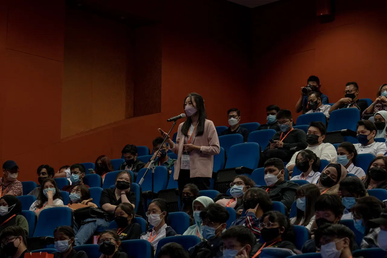 A student stands to ask a question.
