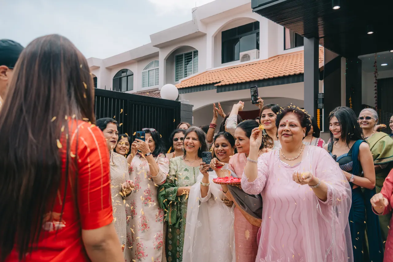 Guests gather on the driveway with garlands.