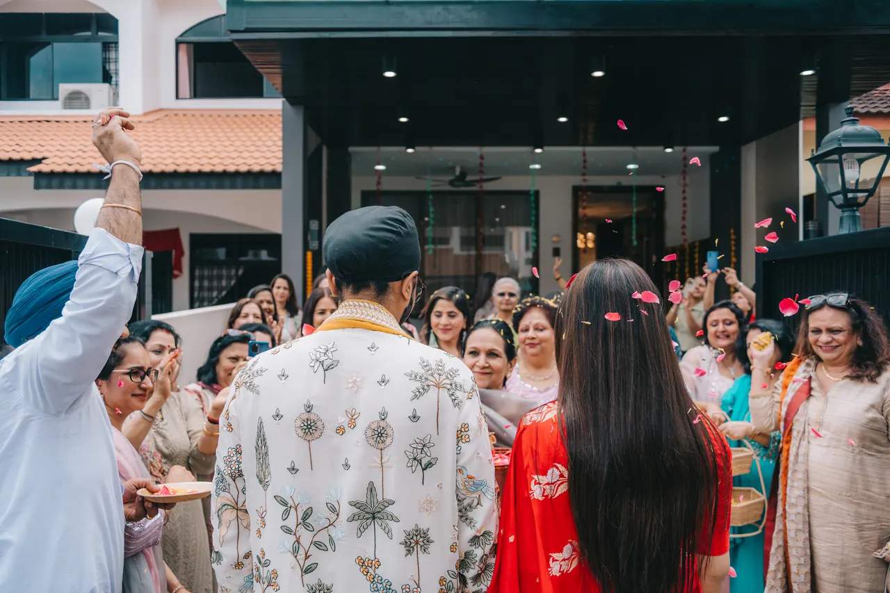 Guests welcome the couple at the gate.