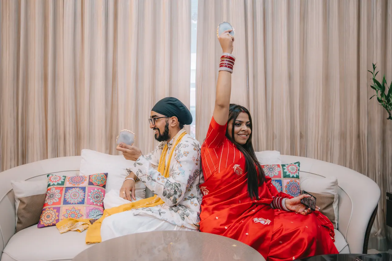 The couple cheer from the sofa.