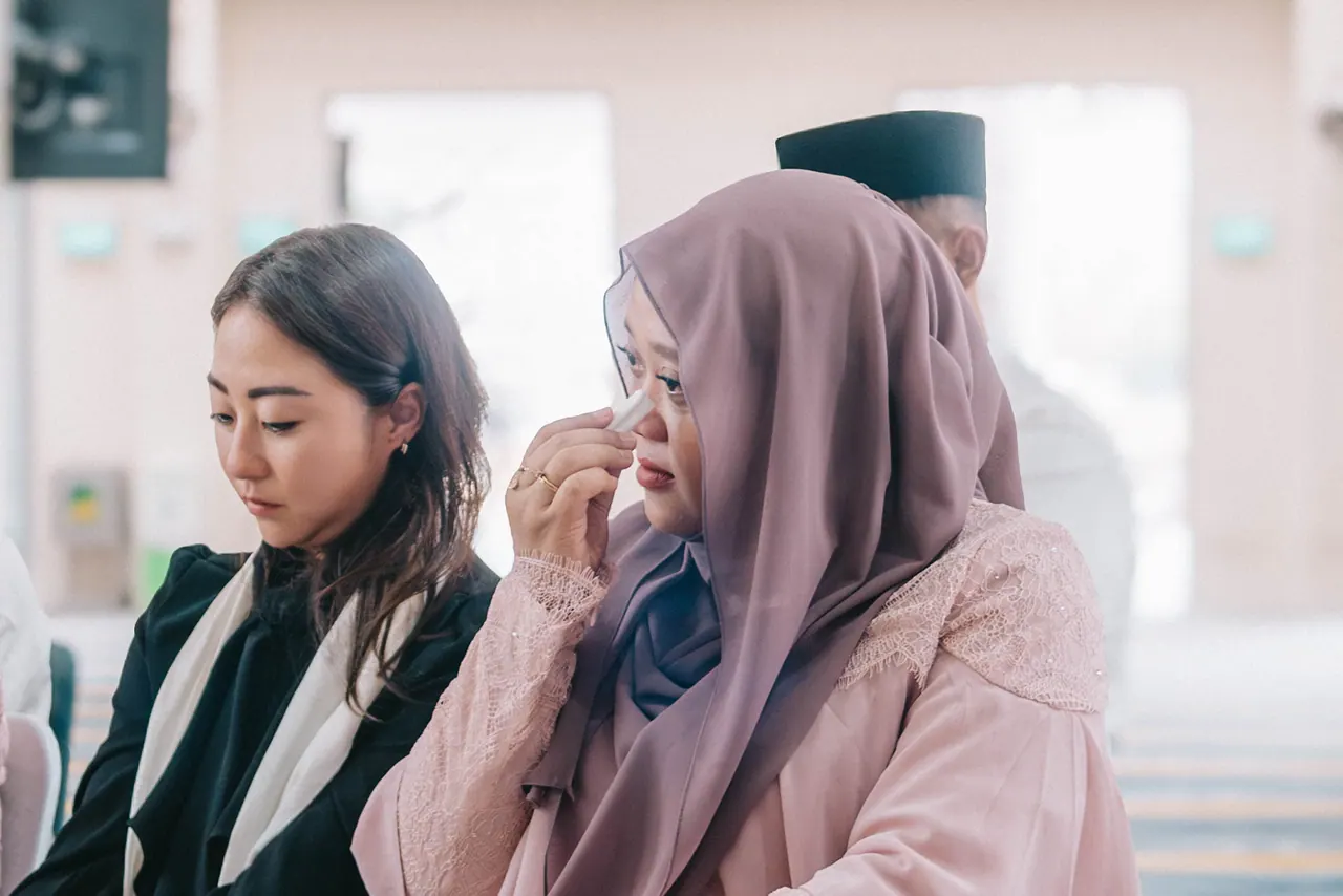 Two women in the audience, one wiping her eyes.