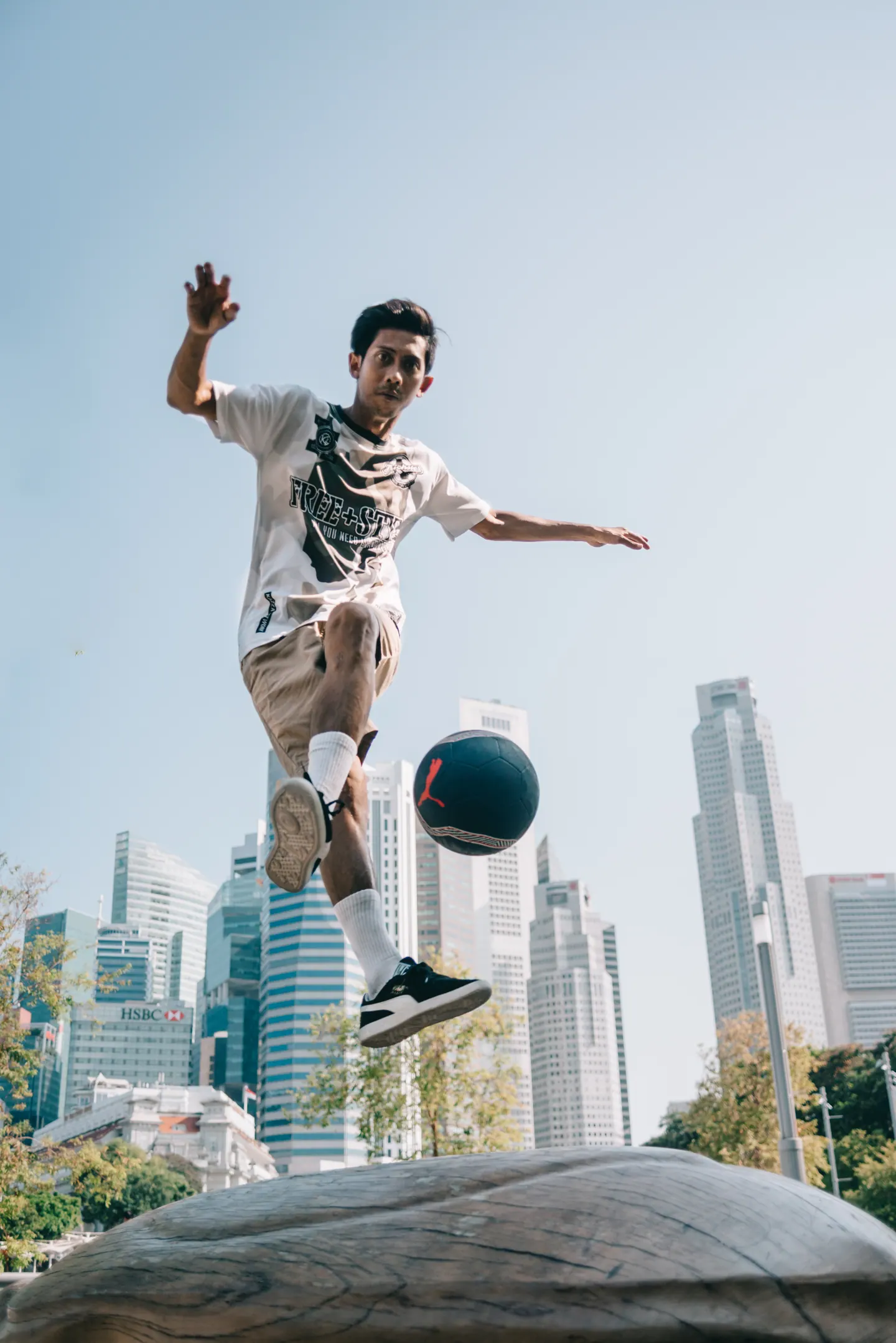 A freestyler leaps, the ball in the air.